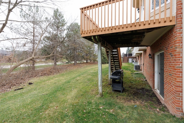 view of yard with a deck and central air condition unit