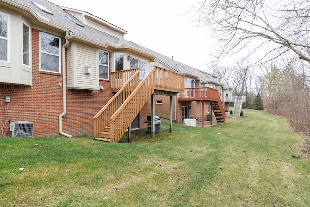 back of house featuring a yard, a deck, and central air condition unit