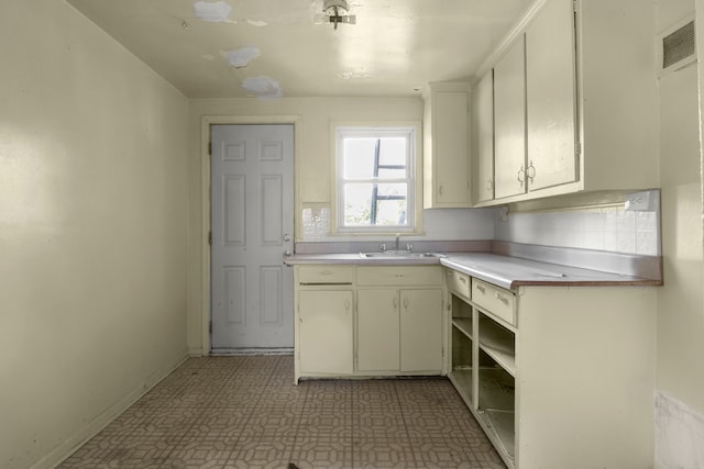 kitchen with tasteful backsplash and sink