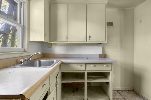 kitchen with cream cabinets and sink