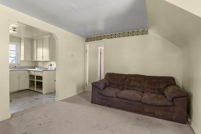 living room with sink, lofted ceiling, and light carpet