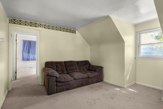 carpeted living room featuring lofted ceiling