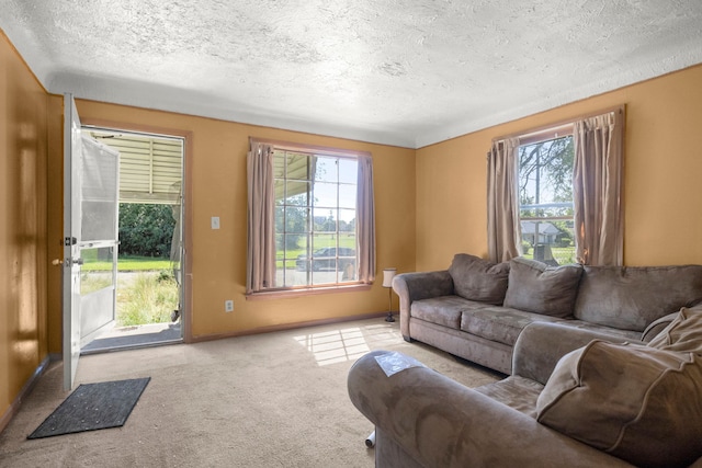 living room with light carpet, plenty of natural light, and a textured ceiling