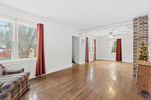 living room with hardwood / wood-style flooring, ceiling fan, and a healthy amount of sunlight