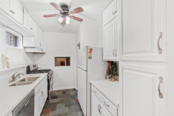 kitchen with decorative backsplash, appliances with stainless steel finishes, white cabinetry, and sink