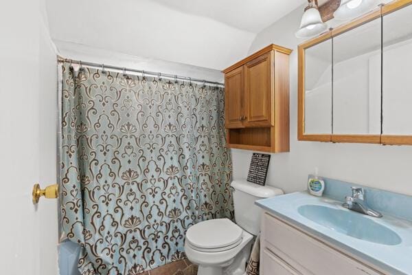 bathroom featuring vanity, a shower with shower curtain, and toilet