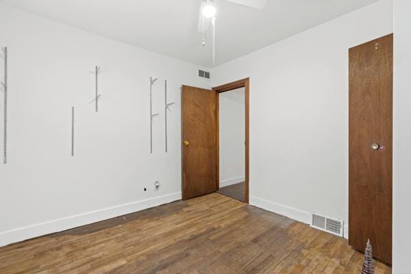 spare room featuring hardwood / wood-style floors and ceiling fan