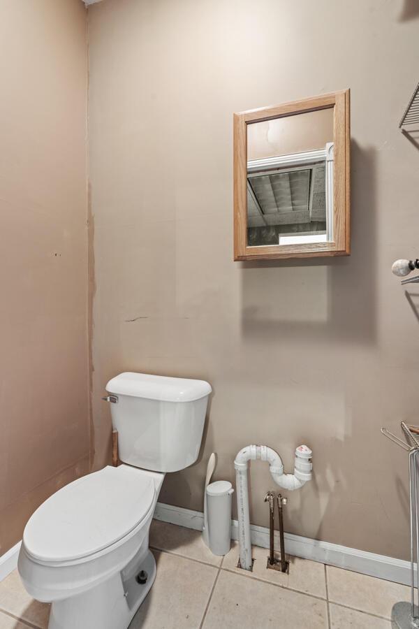 bathroom with toilet and tile patterned floors