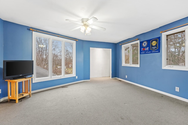 unfurnished living room with carpet flooring and ceiling fan