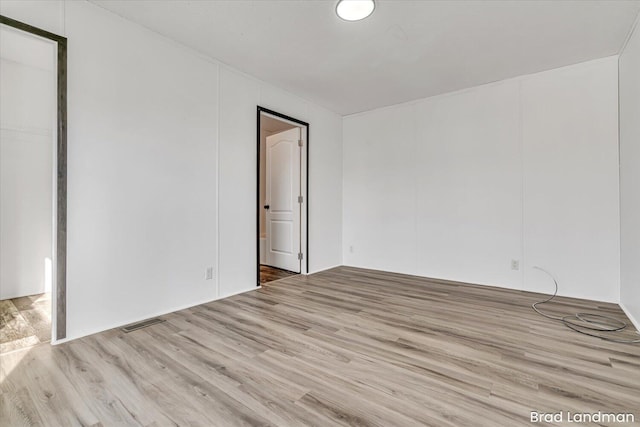 spare room featuring light hardwood / wood-style floors