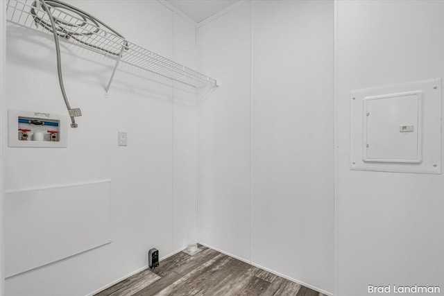 washroom featuring hookup for a washing machine, electric panel, and dark hardwood / wood-style floors