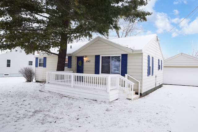 view of front of home with covered porch, an outdoor structure, and a garage