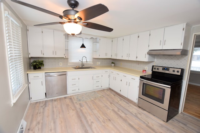 kitchen with exhaust hood, white cabinetry, ceiling fan, and stainless steel appliances