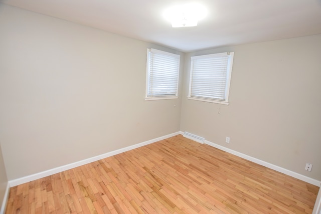 empty room with light hardwood / wood-style flooring