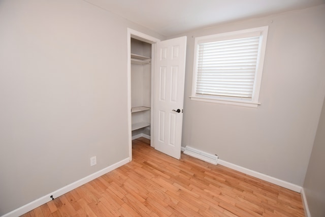 unfurnished bedroom featuring light hardwood / wood-style floors and a closet