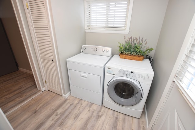 laundry area featuring independent washer and dryer and light wood-type flooring