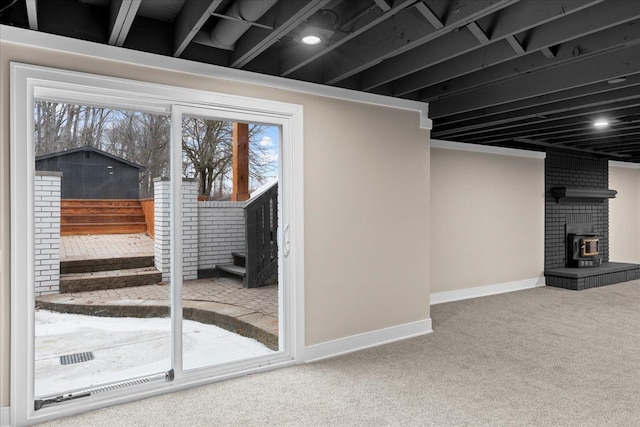 basement featuring carpet floors and brick wall