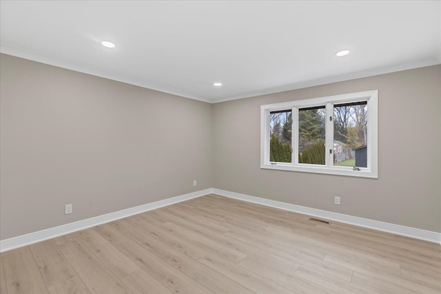 unfurnished room with light wood-type flooring and ornamental molding