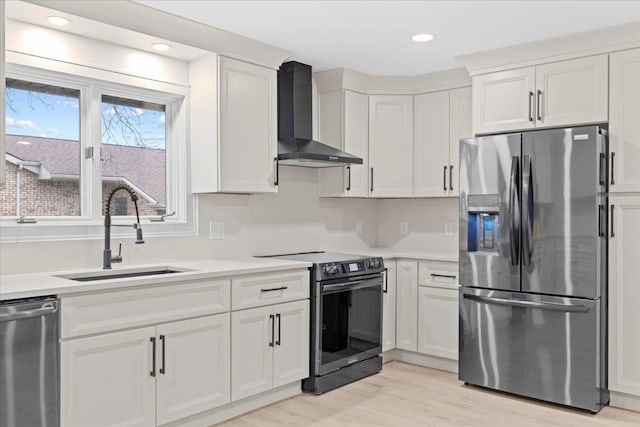 kitchen featuring white cabinets, sink, wall chimney exhaust hood, and stainless steel appliances