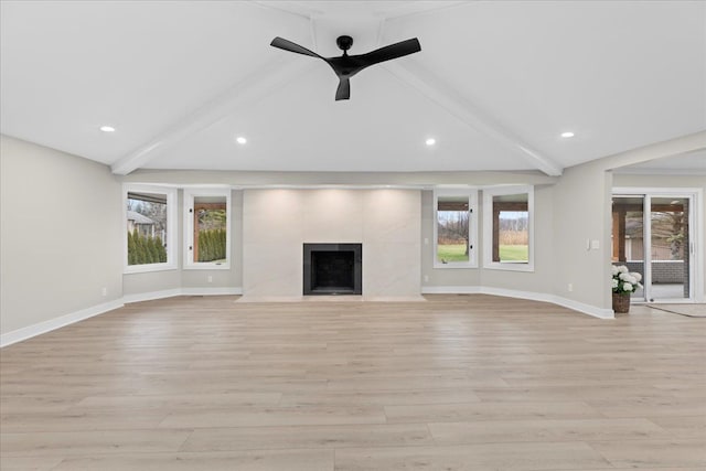 unfurnished living room featuring vaulted ceiling with beams, ceiling fan, light wood-type flooring, and a tile fireplace