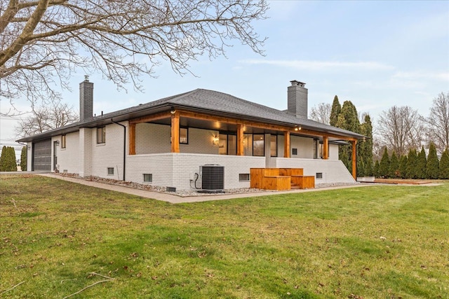 rear view of property with a lawn and cooling unit