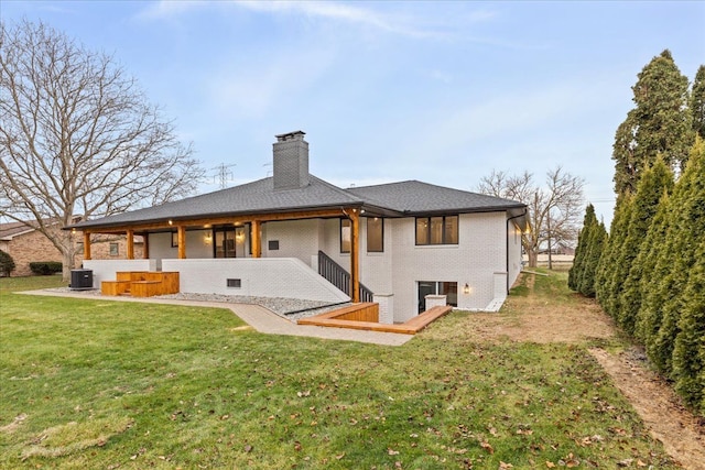 back of property with a yard and central air condition unit