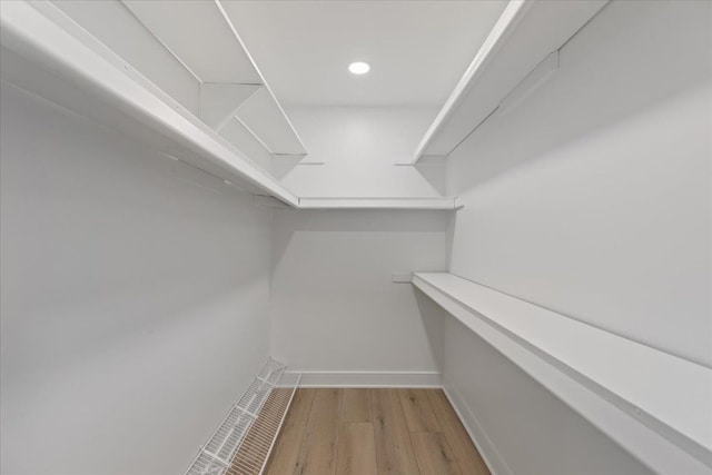 spacious closet with hardwood / wood-style floors