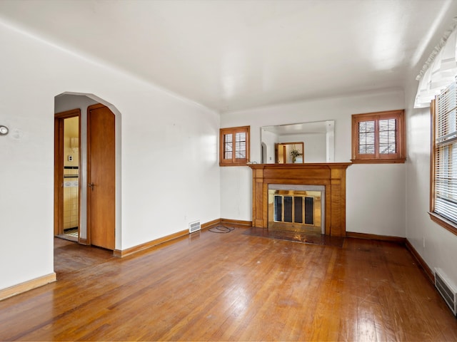 unfurnished living room with hardwood / wood-style flooring