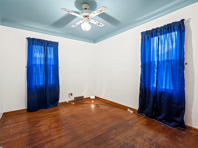 spare room with hardwood / wood-style floors and ceiling fan