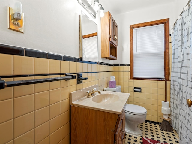 bathroom with tile patterned flooring, vanity, and tile walls