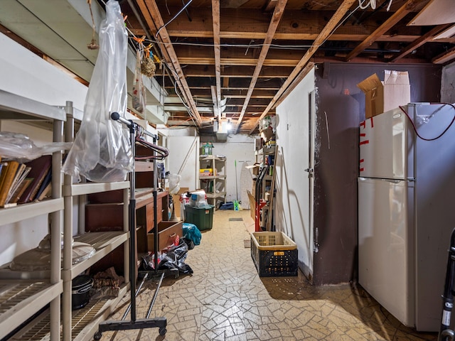 basement with white fridge