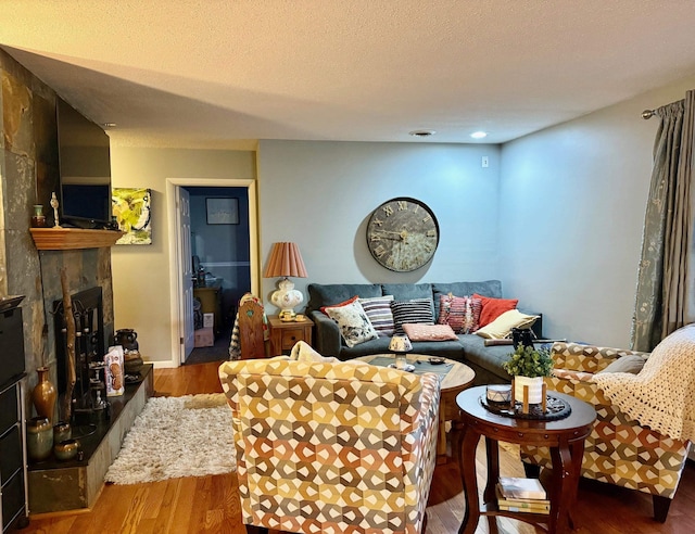 living room featuring hardwood / wood-style flooring and a textured ceiling