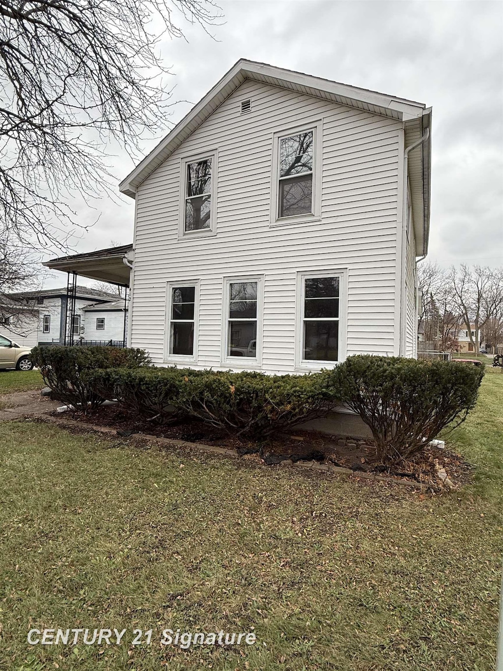 view of side of property with a yard