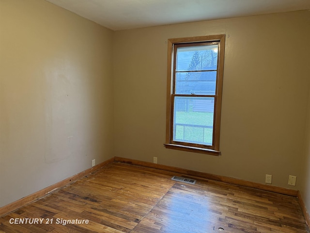 unfurnished room featuring wood-type flooring