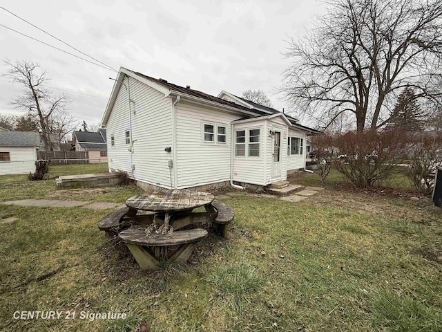 back of house with a lawn