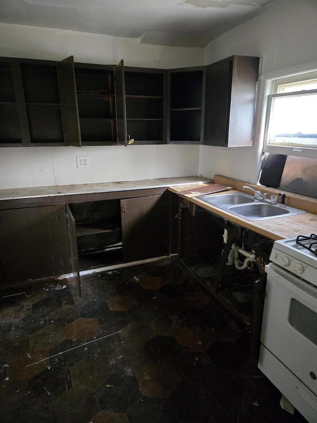 kitchen with white range with gas cooktop and sink