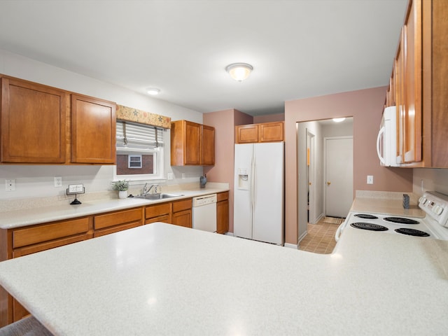 kitchen with kitchen peninsula, a kitchen breakfast bar, white appliances, and sink