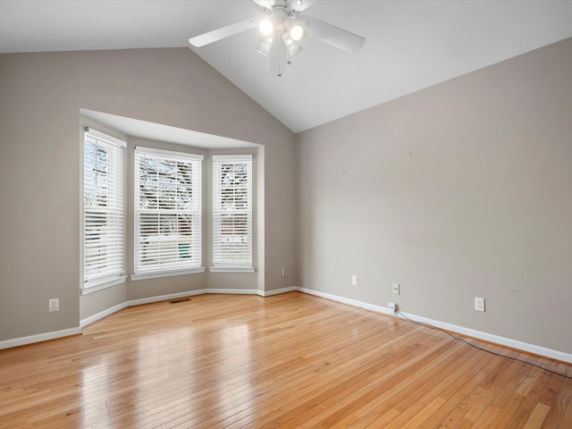 unfurnished room with ceiling fan, vaulted ceiling, and light hardwood / wood-style flooring