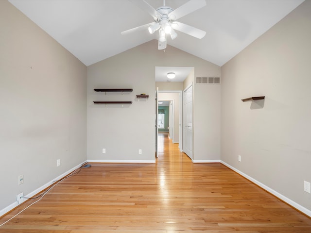 empty room featuring ceiling fan, light hardwood / wood-style flooring, and vaulted ceiling