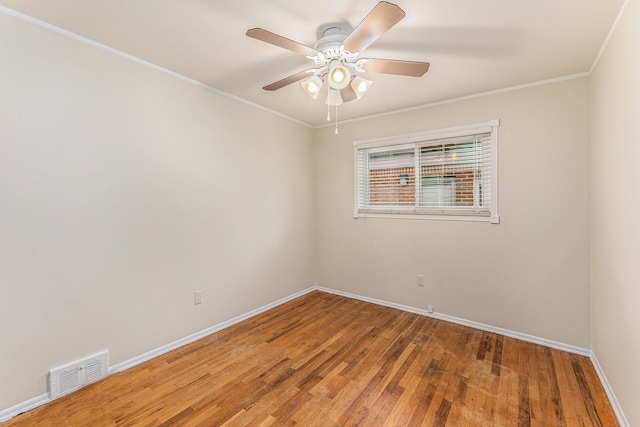 empty room featuring hardwood / wood-style floors, ceiling fan, and crown molding