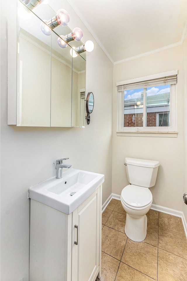 bathroom featuring tile patterned floors, vanity, toilet, and crown molding