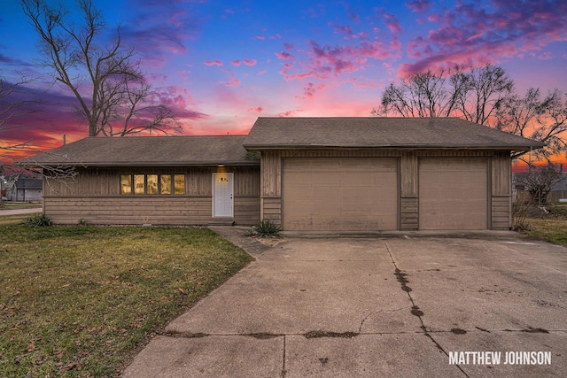 view of front of home with a lawn and a garage