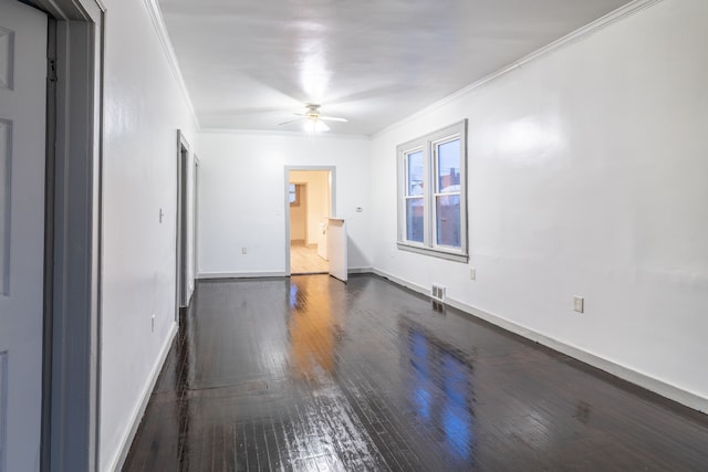 unfurnished room with crown molding, ceiling fan, and dark wood-type flooring