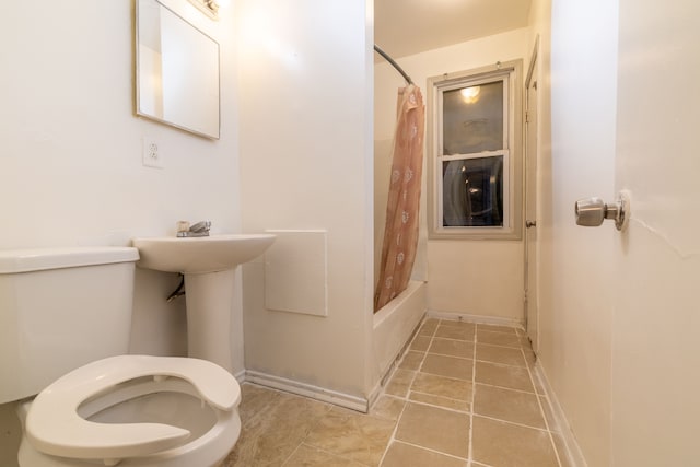 bathroom featuring shower / bath combination with curtain and toilet