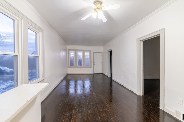 spare room with dark wood-type flooring, ceiling fan, and crown molding