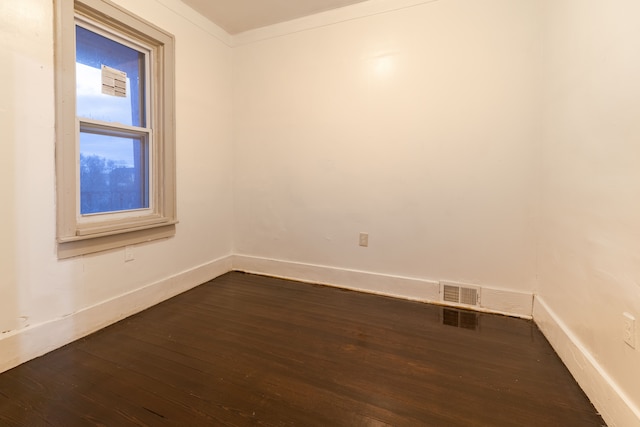 unfurnished room with dark hardwood / wood-style floors and crown molding