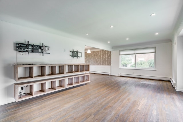 living room featuring wood-type flooring and a baseboard heating unit