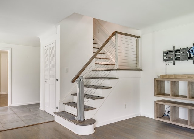 staircase with wood-type flooring