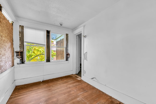 unfurnished room with hardwood / wood-style flooring