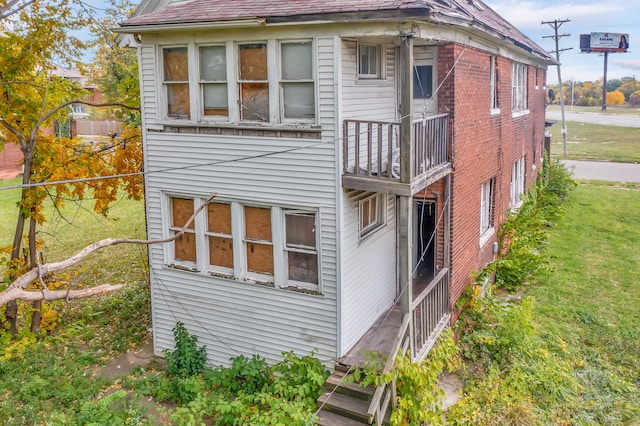 back of property featuring a yard